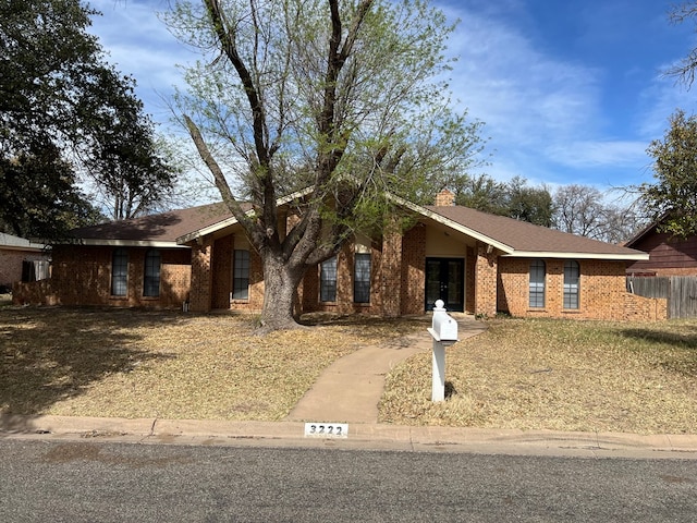 3222 Southland Blvd, San Angelo, TX 76904 - ranch-style house featuring brick siding and a chimney