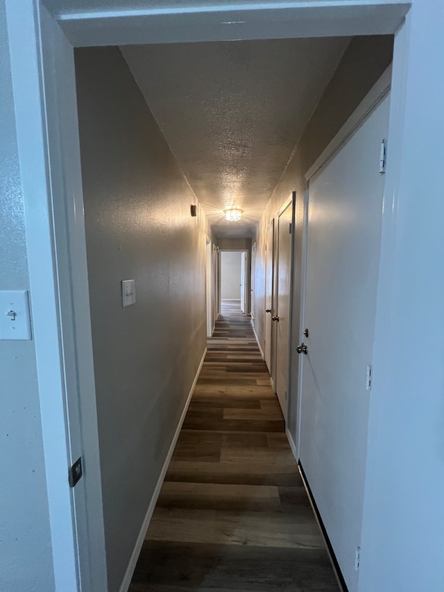 3222 Southland Blvd, San Angelo, TX 76904 - hallway with dark wood-style flooring and a textured ceiling