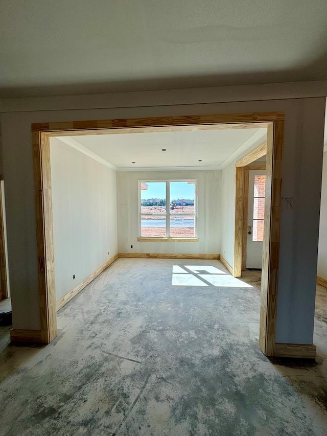 unfurnished room featuring crown molding