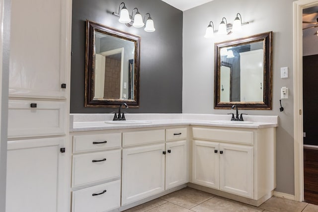 bathroom with double vanity, tile patterned flooring, and a sink