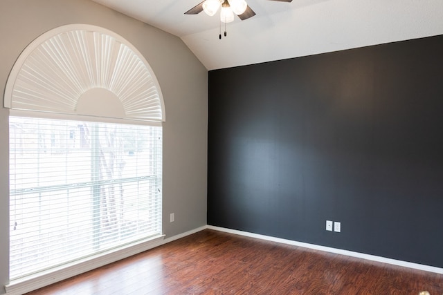 unfurnished room featuring a ceiling fan, lofted ceiling, baseboards, and wood finished floors