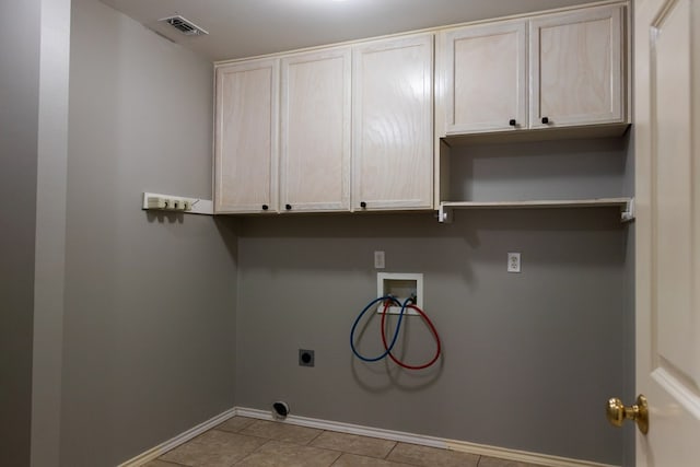 clothes washing area with cabinet space, visible vents, baseboards, hookup for a washing machine, and hookup for an electric dryer