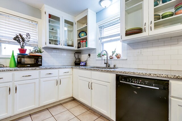 kitchen with sink, light stone counters, black appliances, decorative backsplash, and white cabinets