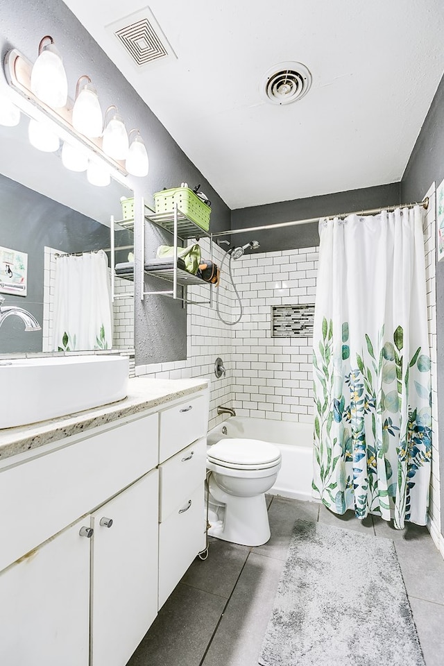 bathroom with vanity, tile patterned floors, and toilet