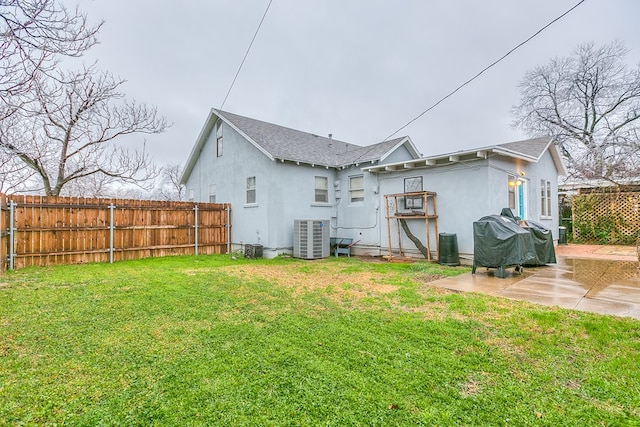 back of house featuring a lawn, a patio area, and central air condition unit