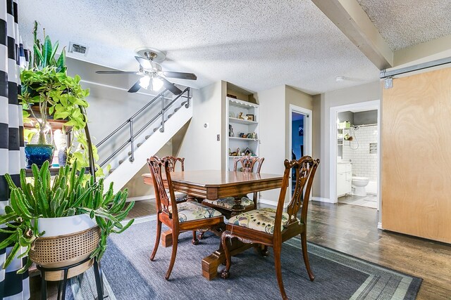 dining room featuring ceiling fan, a textured ceiling, and dark hardwood / wood-style flooring