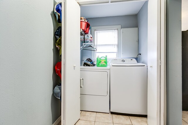 laundry room with light tile patterned floors and washer and dryer