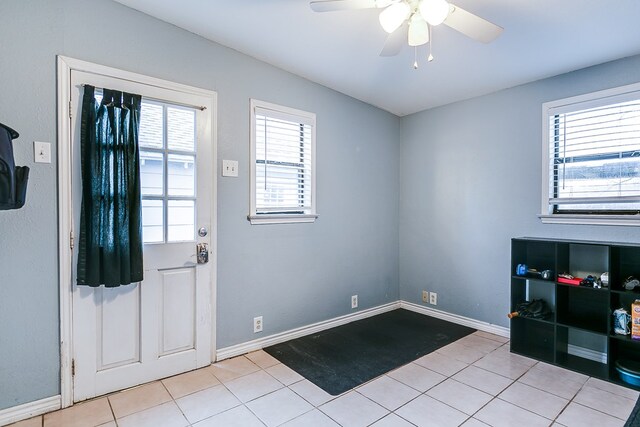 entryway with light tile patterned flooring and ceiling fan