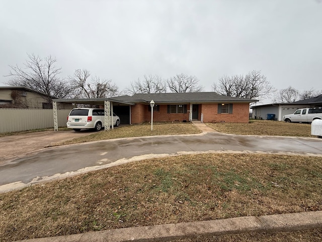 ranch-style home with a front lawn and a carport