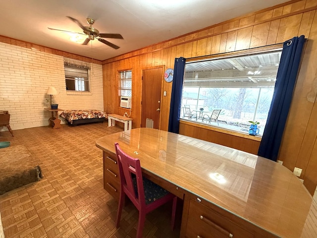 dining space featuring brick wall, a wealth of natural light, and wooden walls