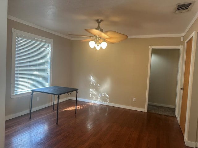 unfurnished dining area featuring crown molding, dark hardwood / wood-style floors, and ceiling fan