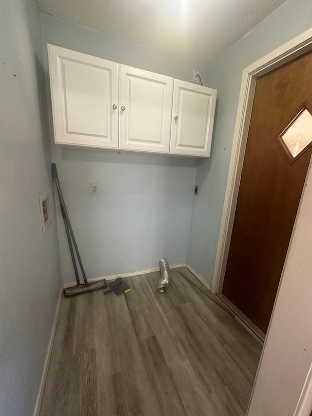 clothes washing area featuring washer hookup, hardwood / wood-style floors, cabinets, and hookup for an electric dryer