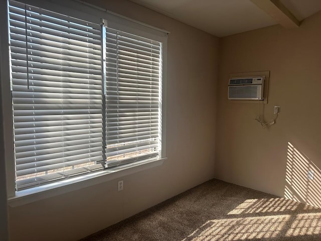 unfurnished room featuring a wall unit AC, plenty of natural light, and carpet