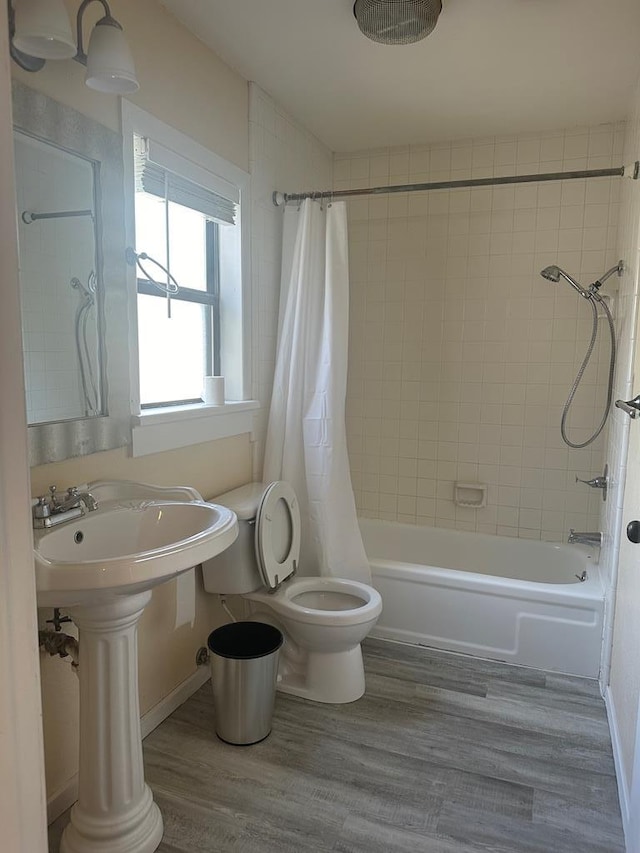 bathroom with shower / bath combination with curtain, toilet, and hardwood / wood-style flooring