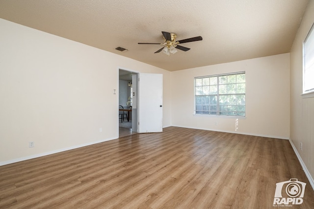 spare room featuring a textured ceiling, light hardwood / wood-style floors, and ceiling fan