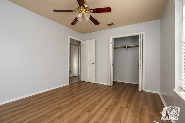 unfurnished bedroom with ceiling fan, hardwood / wood-style floors, and a closet