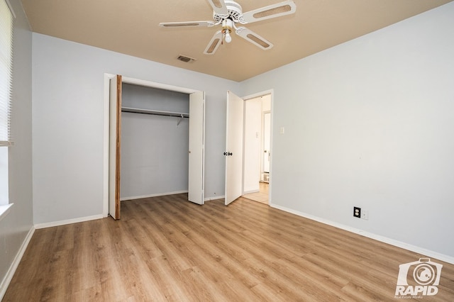 unfurnished bedroom featuring ceiling fan, a closet, and light wood-type flooring