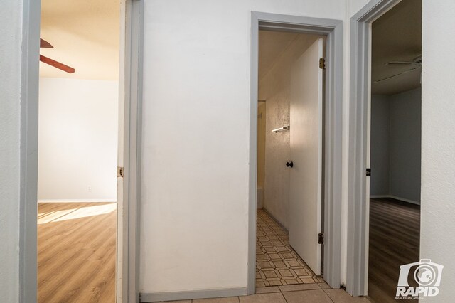 hall with light tile patterned floors