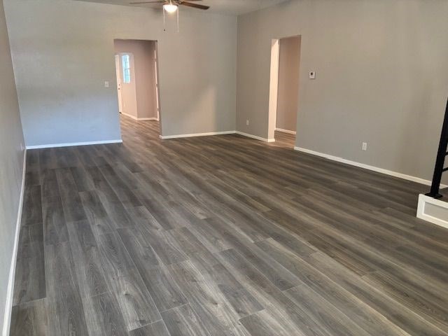 spare room with ceiling fan and dark hardwood / wood-style flooring