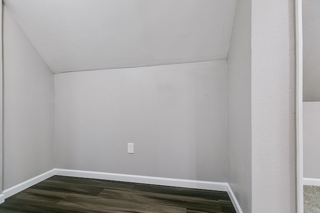 bonus room with lofted ceiling and dark hardwood / wood-style flooring