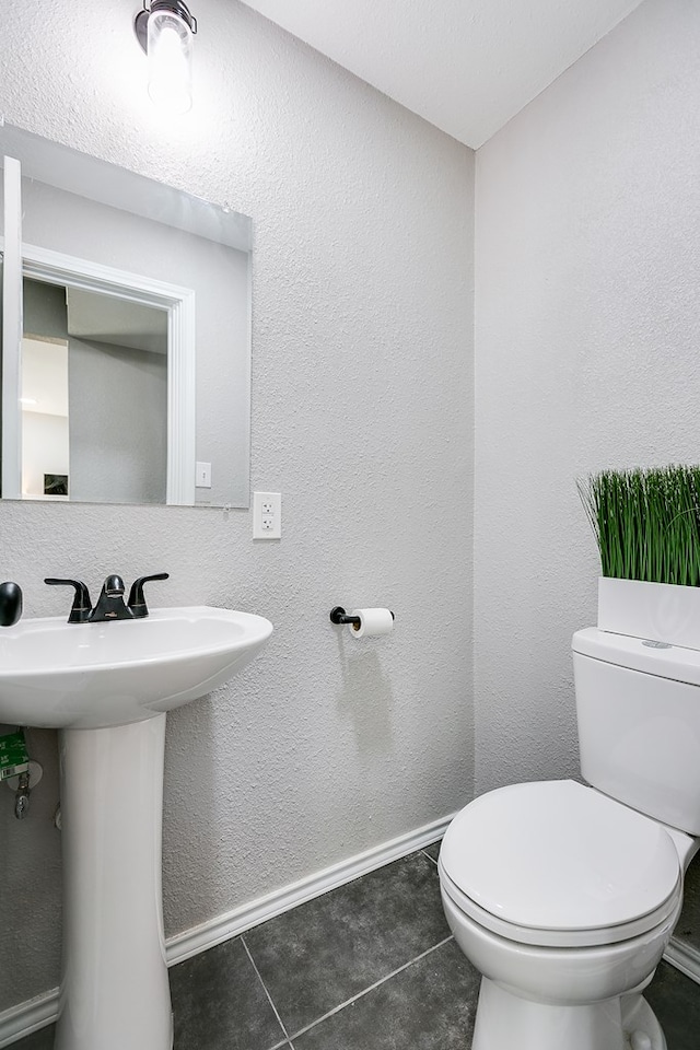 bathroom with tile patterned flooring, sink, and toilet