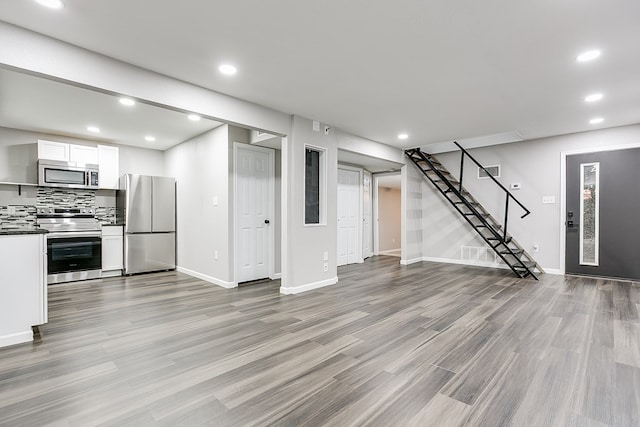 unfurnished living room featuring light wood-type flooring