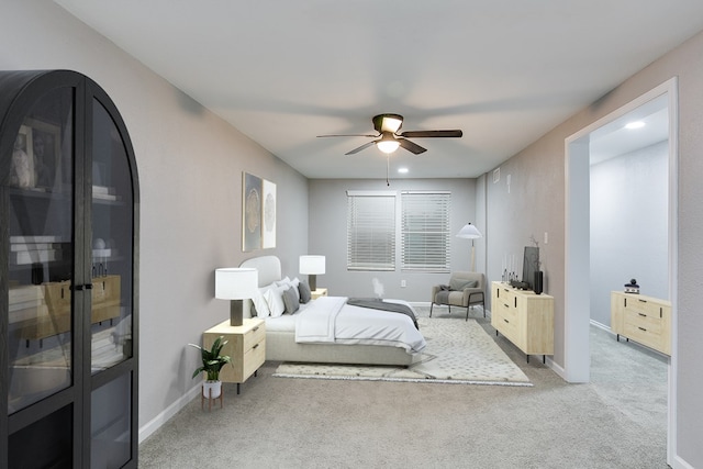 bedroom featuring light carpet and ceiling fan