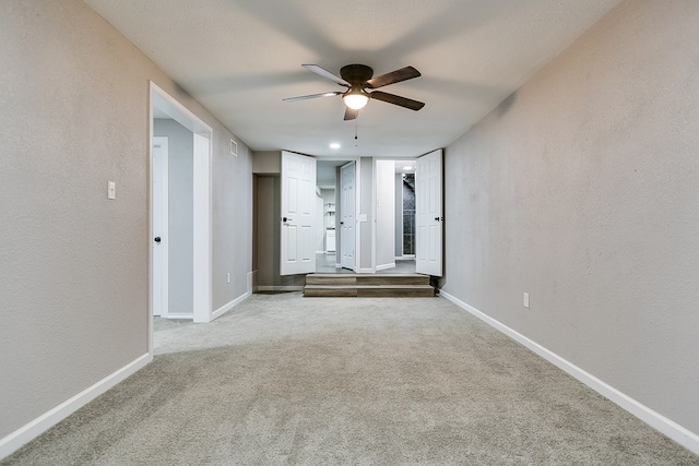 carpeted empty room featuring ceiling fan