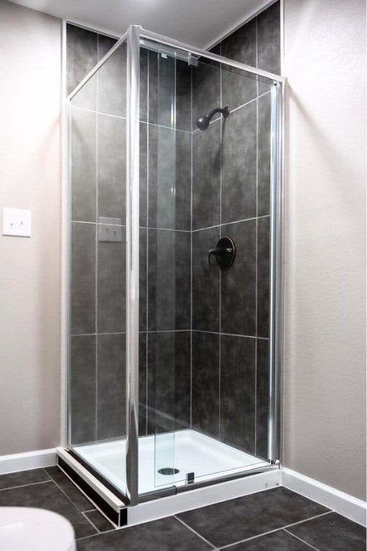 bathroom with tile patterned flooring and a shower with shower door