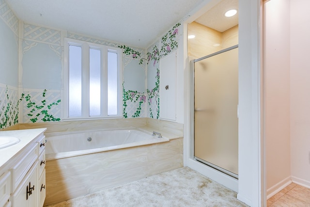 bathroom featuring vanity and shower with separate bathtub