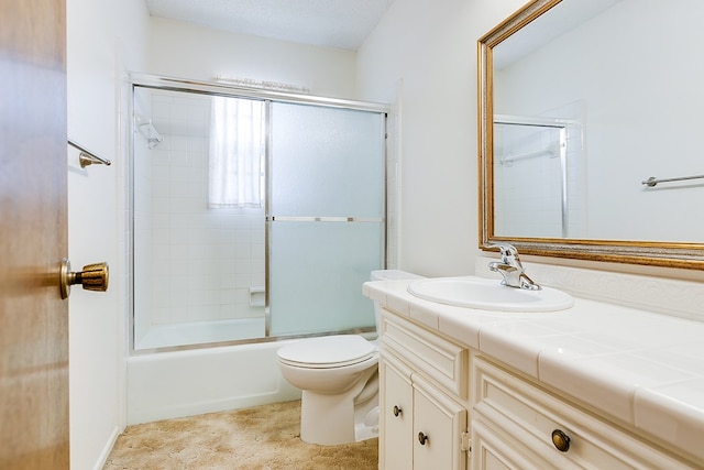 full bathroom featuring enclosed tub / shower combo, vanity, and toilet