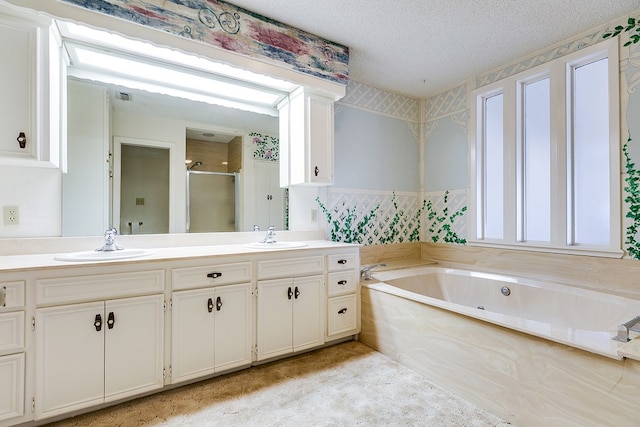 bathroom with vanity, separate shower and tub, and a textured ceiling