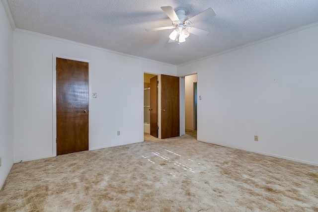 unfurnished bedroom featuring crown molding, light colored carpet, a textured ceiling, and ceiling fan