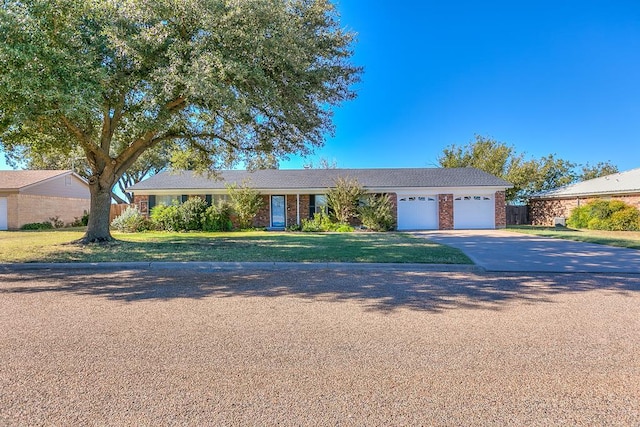 single story home with a garage and a front lawn