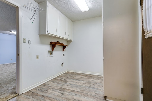 laundry area featuring cabinets, light hardwood / wood-style flooring, a textured ceiling, washer hookup, and hookup for an electric dryer