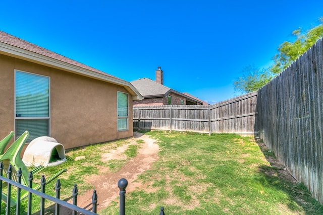 view of yard with a fenced backyard