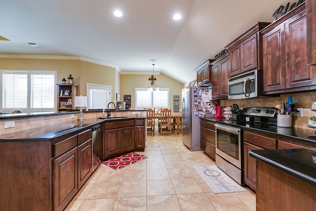 kitchen with dark countertops, tasteful backsplash, a sink, stainless steel appliances, and visible vents