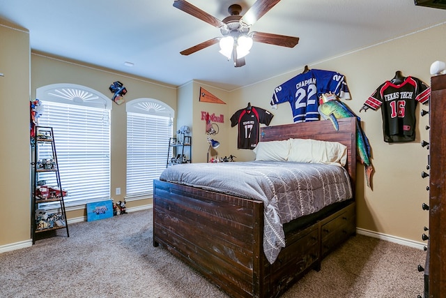 bedroom with a ceiling fan, baseboards, and carpet