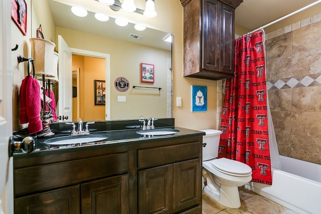full bath with toilet, a sink, visible vents, and double vanity