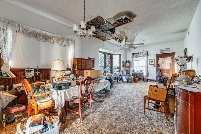 219 Bird St, San Angelo, TX 79603 - interior space featuring carpet flooring, ceiling fan with notable chandelier, and a textured ceiling