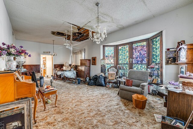 219 Bird St, San Angelo, TX 79603 - interior space with carpet flooring, ceiling fan with notable chandelier, french doors, and a textured ceiling