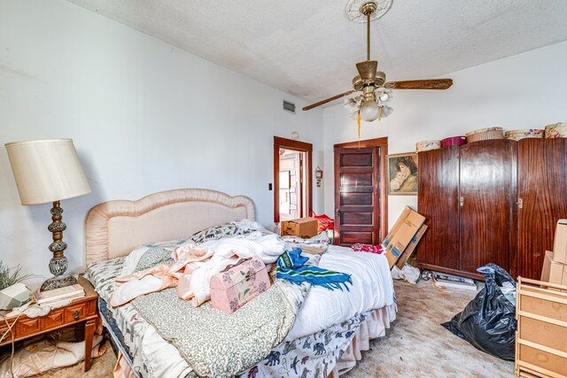 219 Bird St, San Angelo, TX 79603 - carpeted bedroom with visible vents, a textured ceiling, and ceiling fan