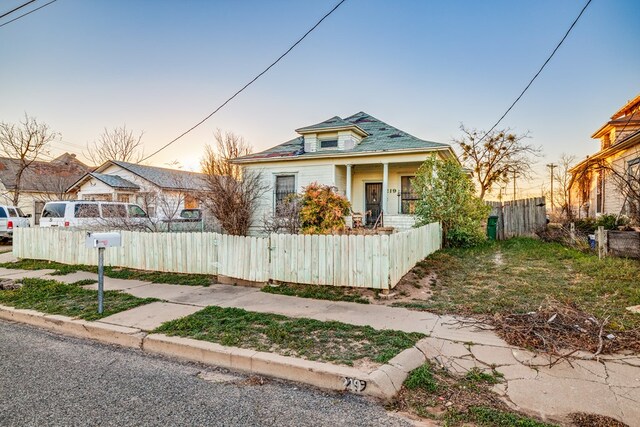 219 Bird St, San Angelo, TX 79603 - bungalow-style home with a fenced front yard, a porch, and a gate