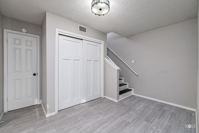 interior space featuring a textured ceiling