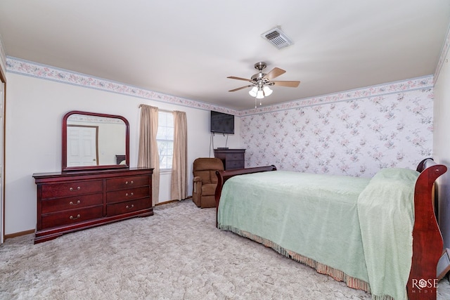 bedroom with visible vents, carpet floors, wallpapered walls, baseboards, and ceiling fan