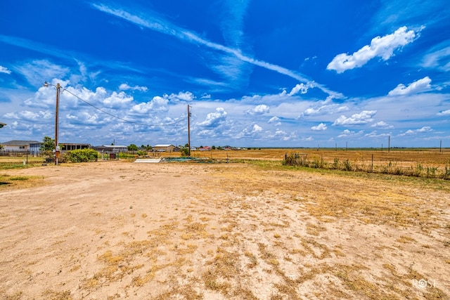 view of yard with a rural view and fence