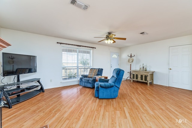 living area featuring ceiling fan, visible vents, and light wood-style flooring