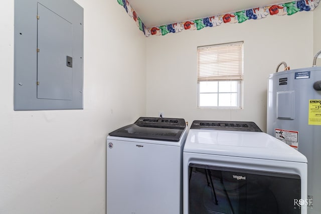 washroom featuring electric panel, laundry area, water heater, and washer and clothes dryer