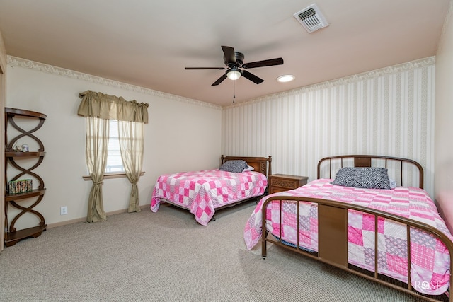 carpeted bedroom featuring visible vents, baseboards, and ceiling fan
