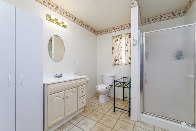 full bath featuring toilet, a stall shower, and vanity
